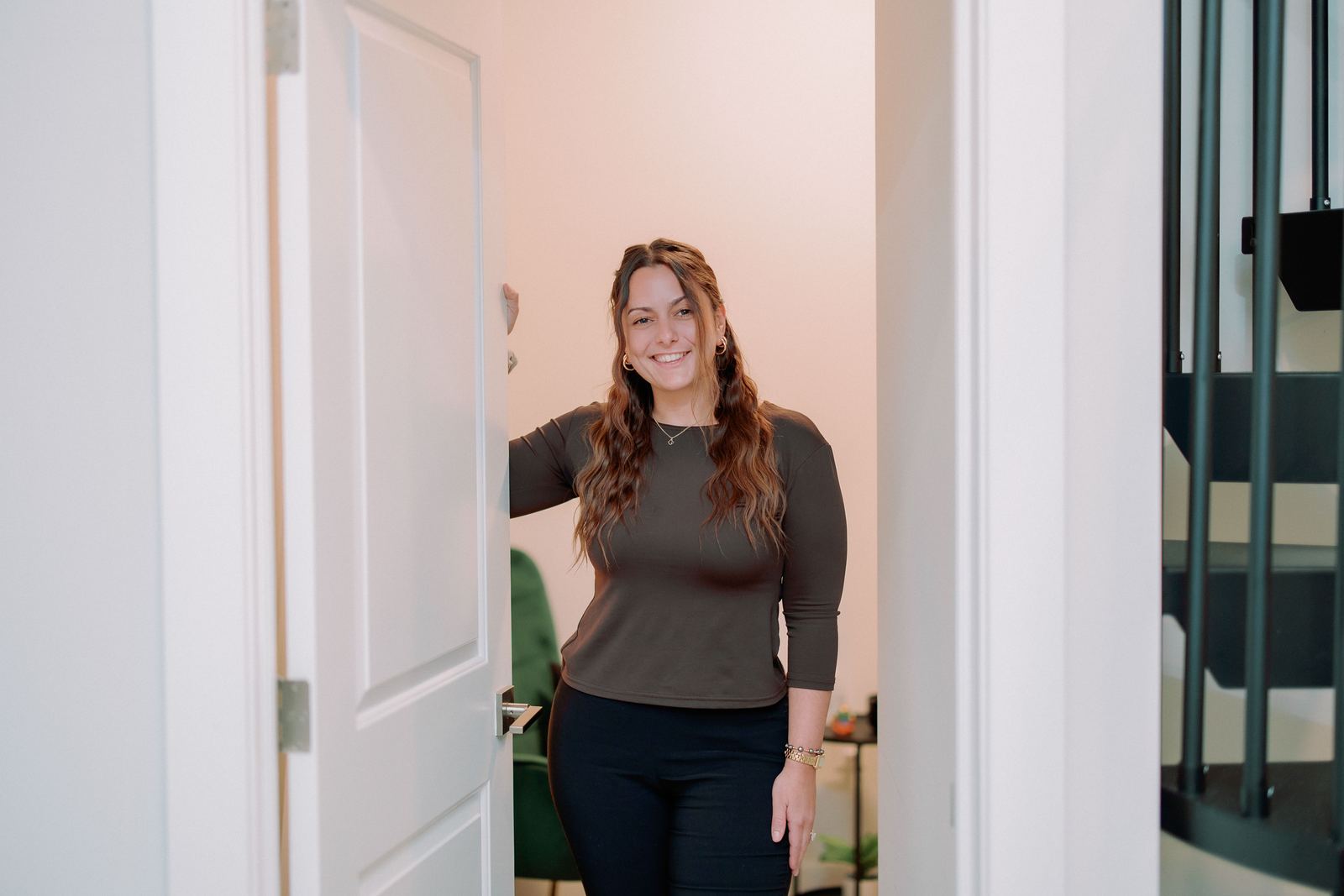 Jennifer Lombardo, LCSW, smiling in an open doorway