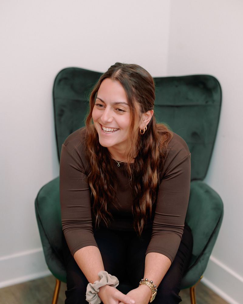Jennifer Lombardo laughing in a green armchair